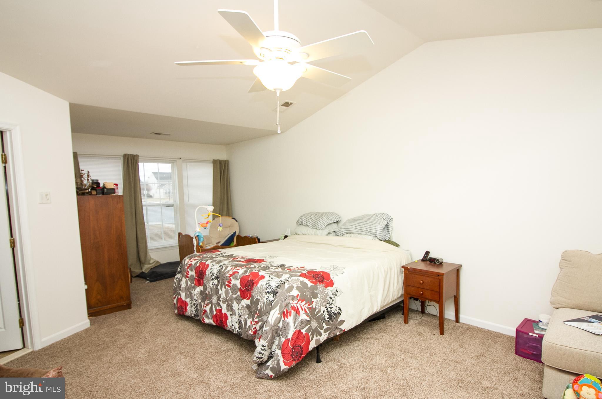 1253 Steed Street Ranson, WV 25438 - Photo 15 of 18 a bedroom with a bed and a chandelier