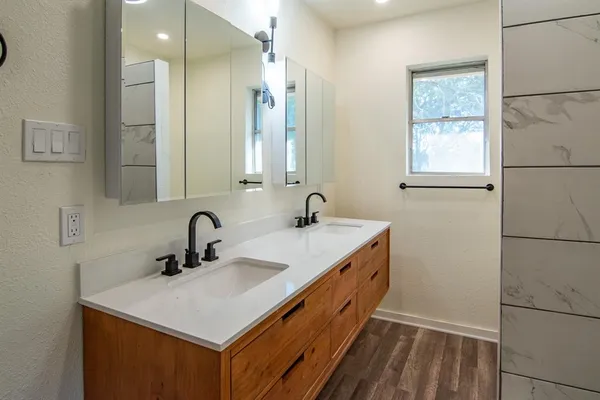 a bathroom with a bathtub and shower