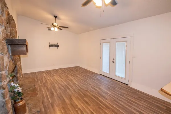 a view of kitchen with granite countertop cabinets and refrigerator
