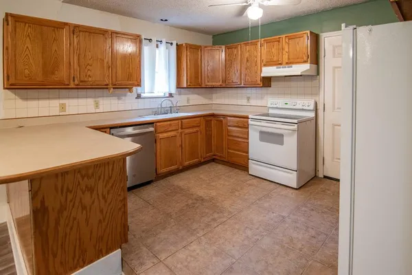 a kitchen with wooden cabinets and sink
