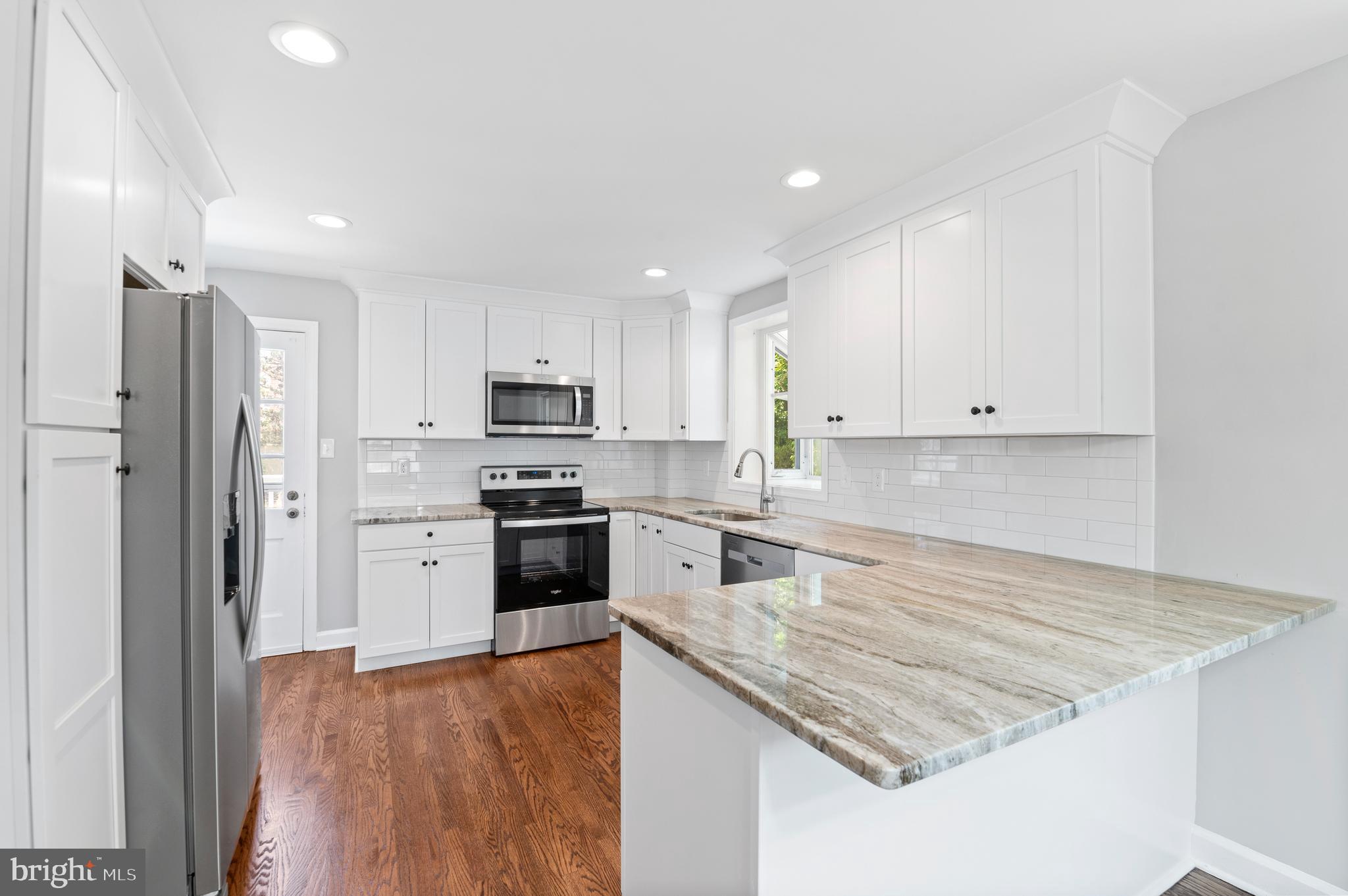 3731 School Lane Newtown Square, PA 19073 - Photo 13 of 31 a kitchen with granite countertop stainless steel appliances and wooden cabinets