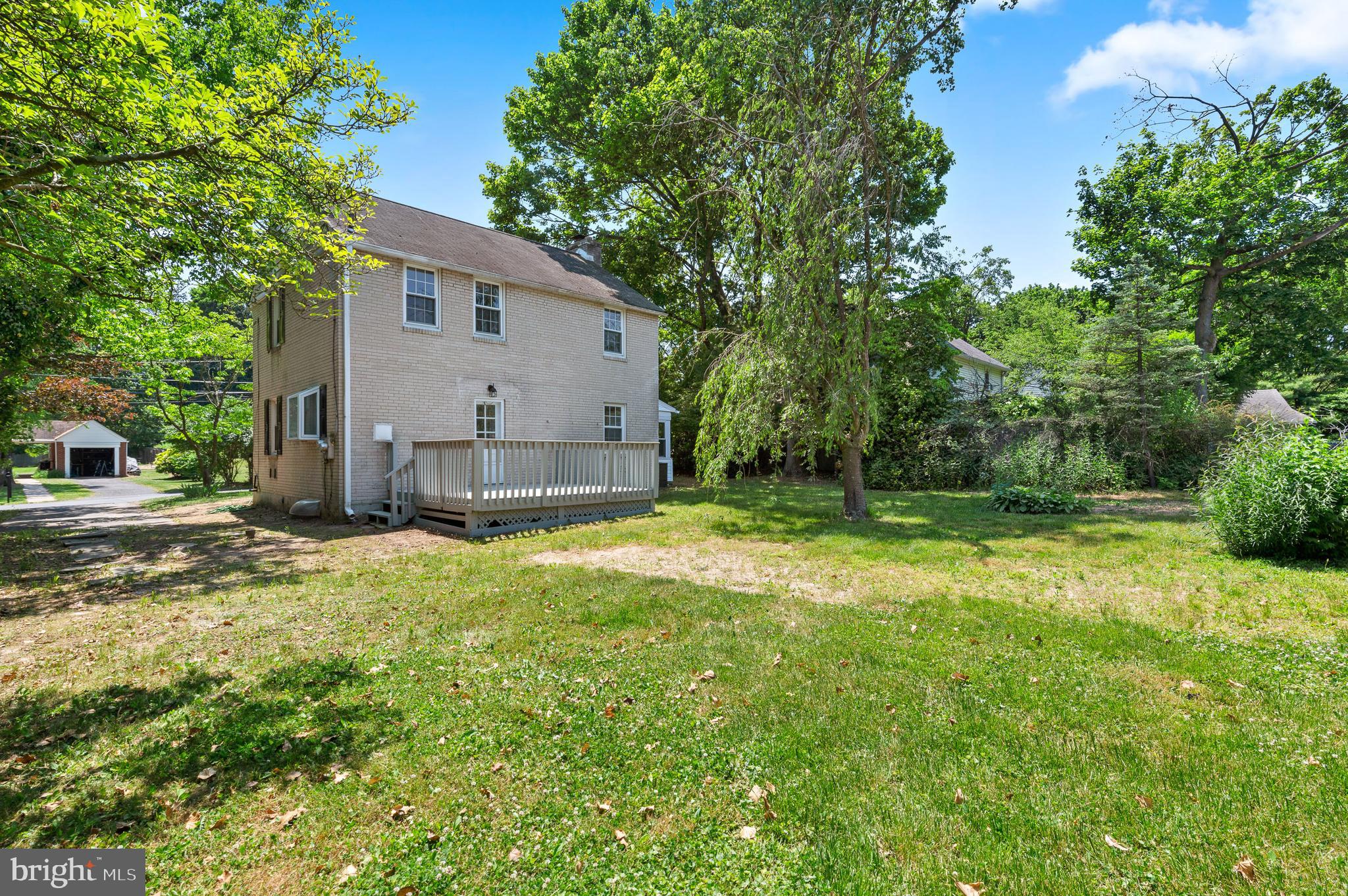 3731 School Lane Newtown Square, PA 19073 - Photo 3 of 31 a view of a backyard with large trees and plants