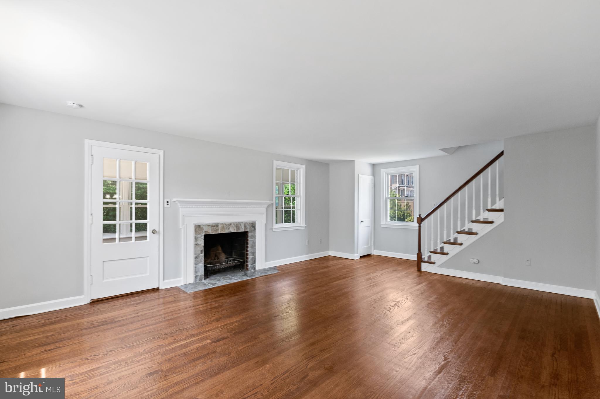 3731 School Lane Newtown Square, PA 19073 - Photo 5 of 31 a view of an empty room with wooden floor fireplace and a window
