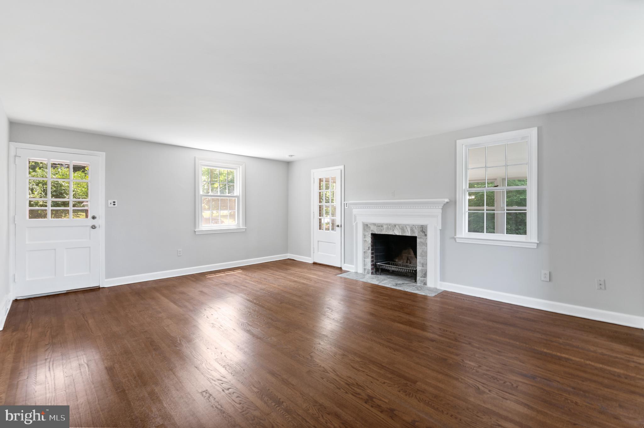 3731 School Lane Newtown Square, PA 19073 - Photo 7 of 31 a view of empty room with wooden floor and fireplace