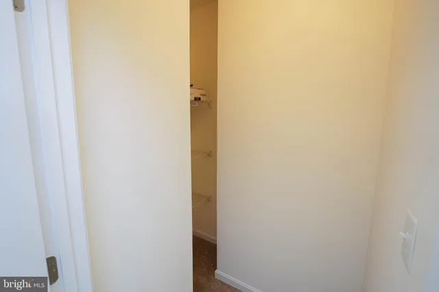 a view of a kitchen with microwave and furniture