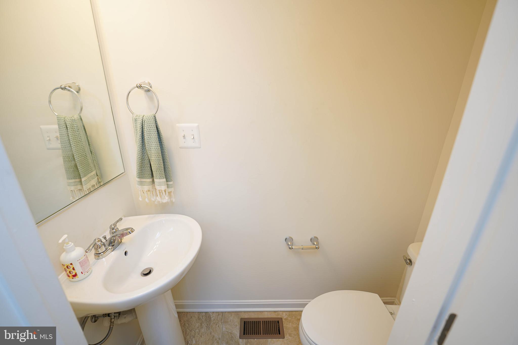 322 Appleby School Road Cambridge, MD 21613 - Photo 19 of 58 a bathroom with a sink mirror and toilet