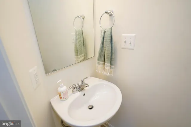 a view of empty room with wooden floor and fireplace