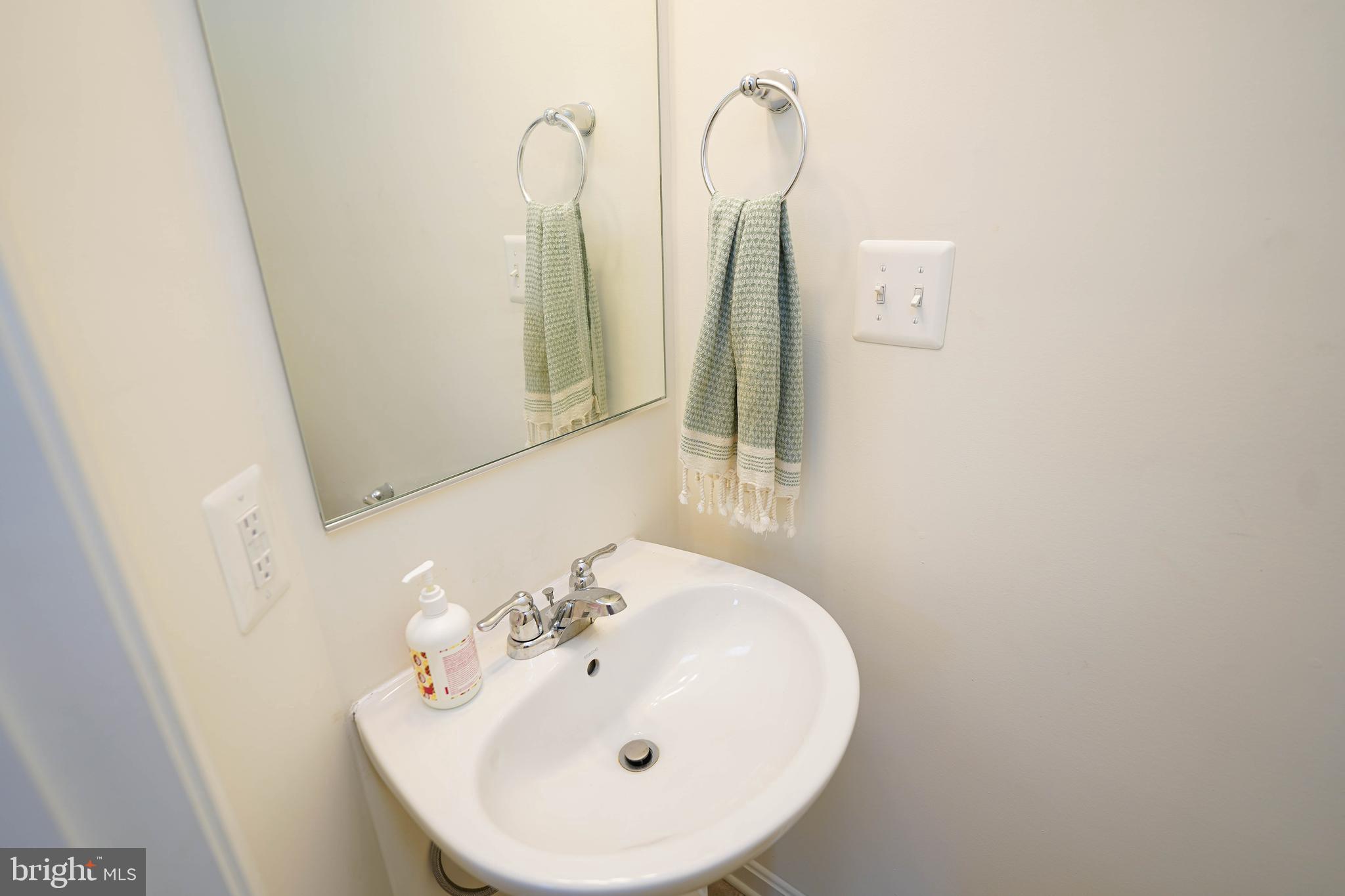 322 Appleby School Road Cambridge, MD 21613 - Photo 20 of 58 a bathroom with a sink and a mirror