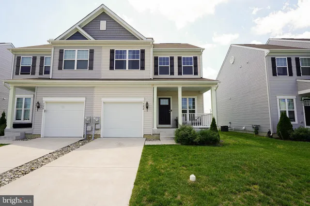 a front view of a house with a yard and porch