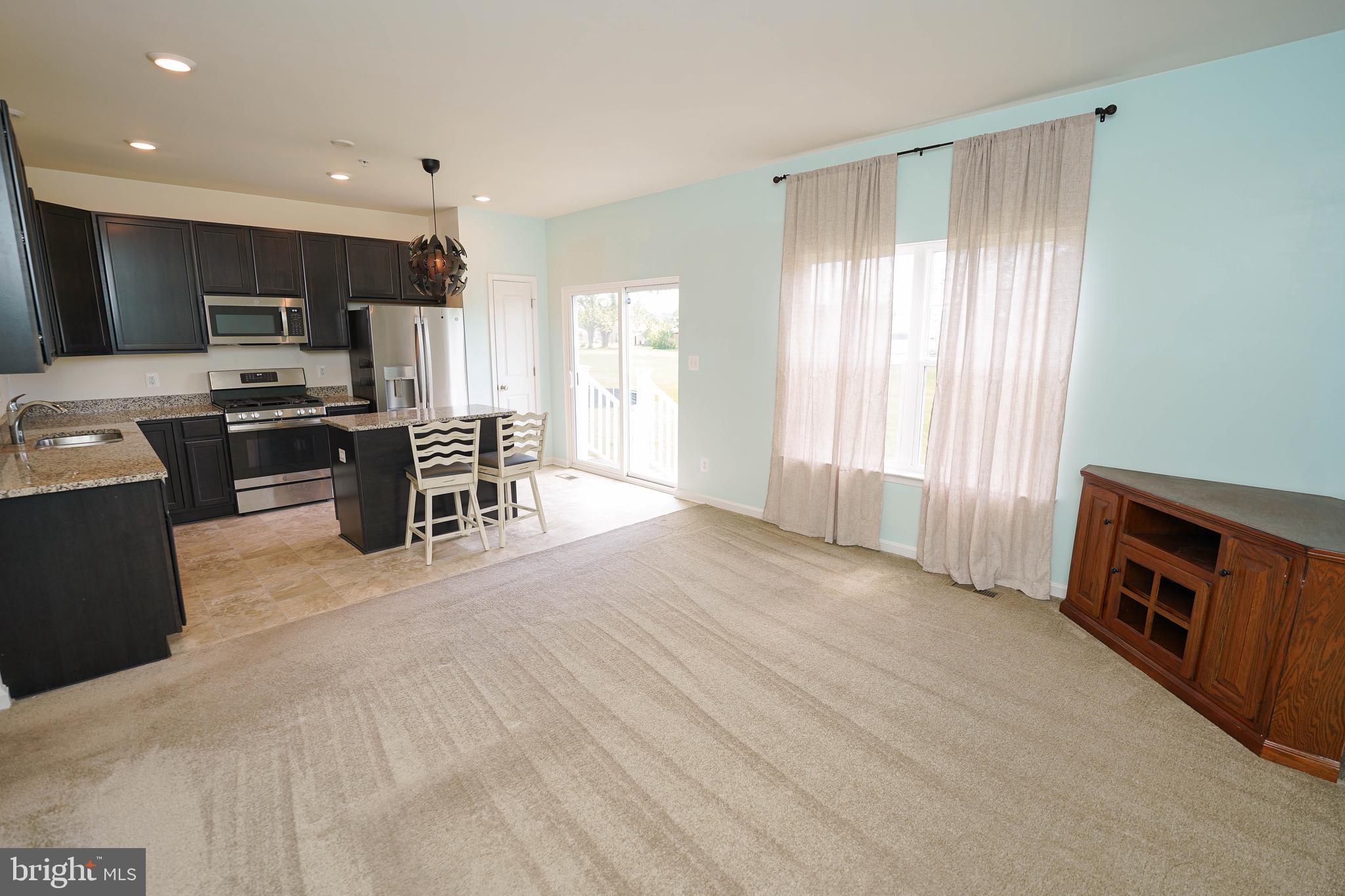 322 Appleby School Road Cambridge, MD 21613 - Photo 24 of 58 a view of a kitchen with microwave and furniture