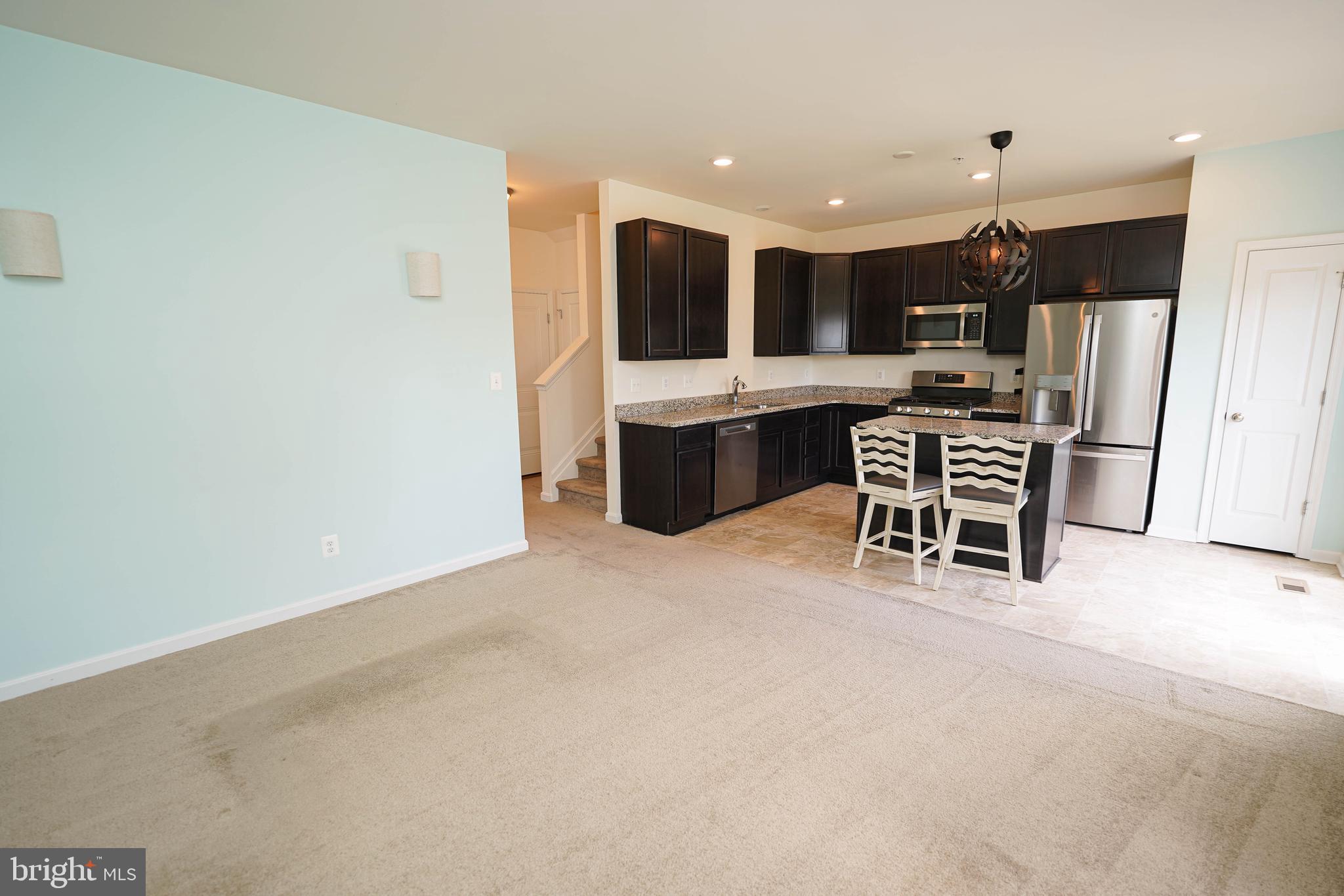 322 Appleby School Road Cambridge, MD 21613 - Photo 25 of 58 a large kitchen with a table and chairs in it