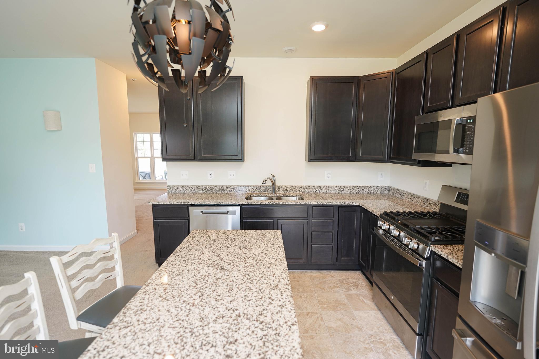 322 Appleby School Road Cambridge, MD 21613 - Photo 28 of 58 a kitchen with stainless steel appliances granite countertop a sink stove and refrigerator