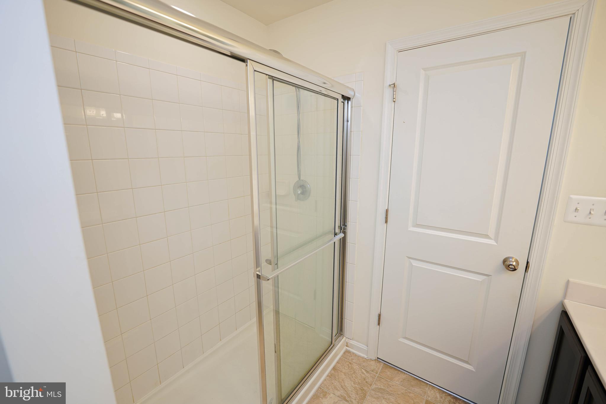 322 Appleby School Road Cambridge, MD 21613 - Photo 41 of 58 a bathroom with a shower and a glass door