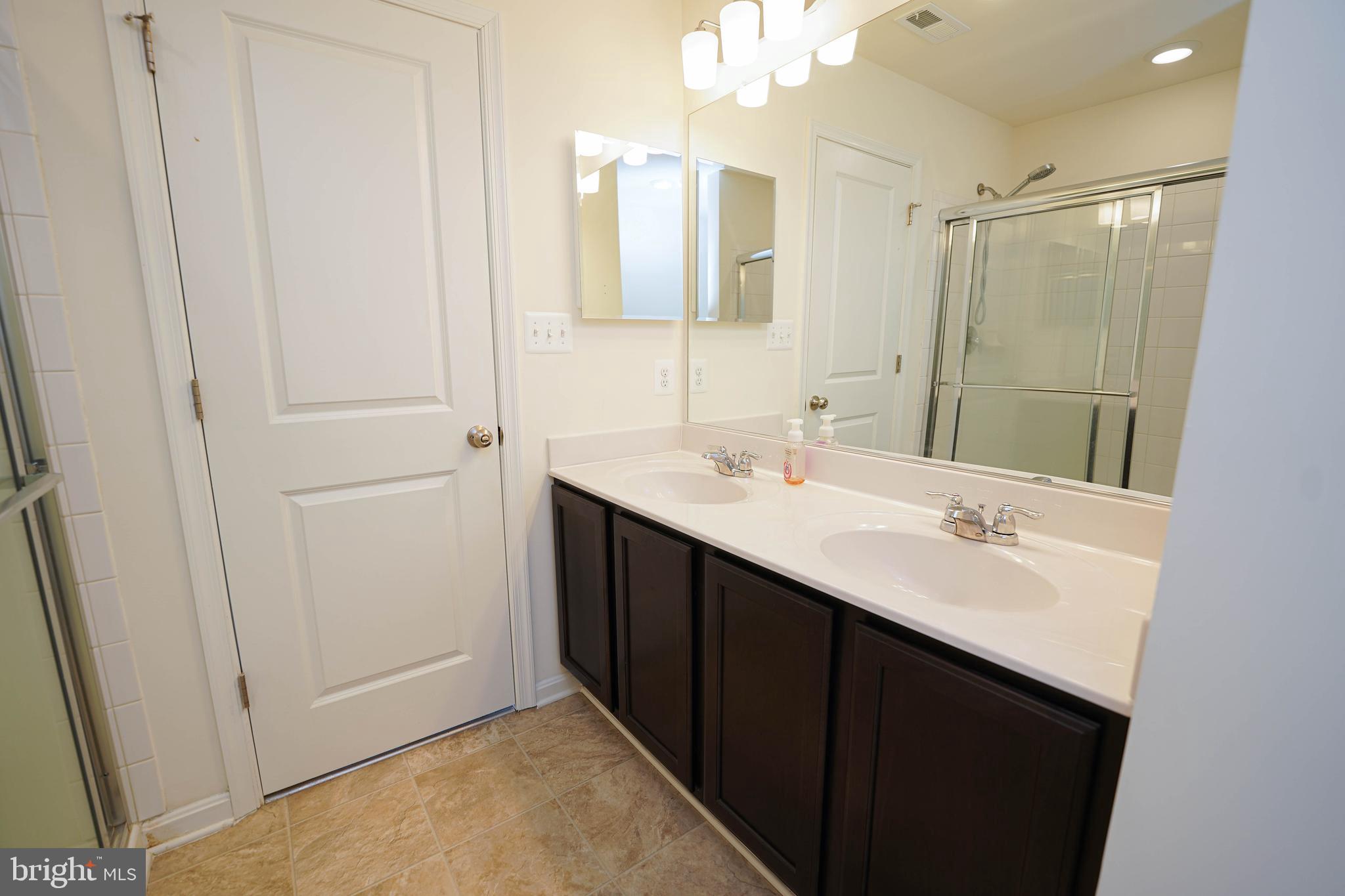 322 Appleby School Road Cambridge, MD 21613 - Photo 42 of 58 a bathroom with a double vanity sink and mirror