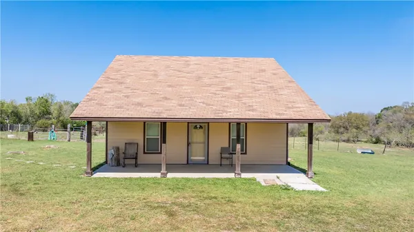 a view of a house with backyard porch and garden