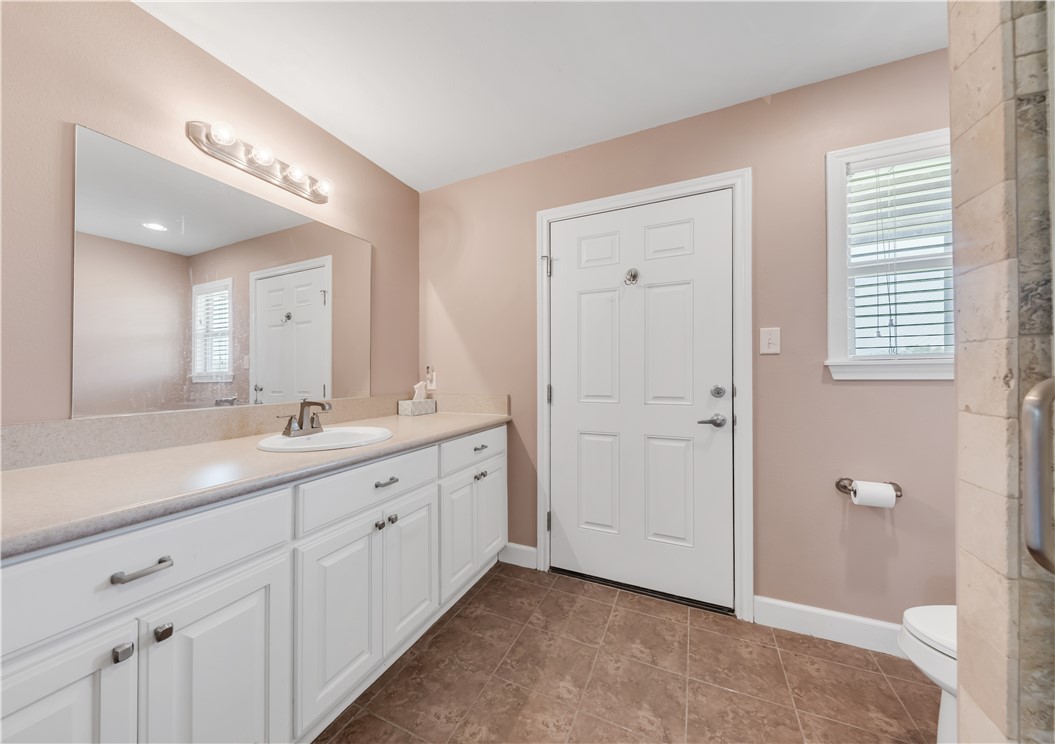 5732 Rose Hill Road Calvert, TX 77837 - Photo 10 of 46 a spacious bathroom with a double vanity sink a large mirror and a shower