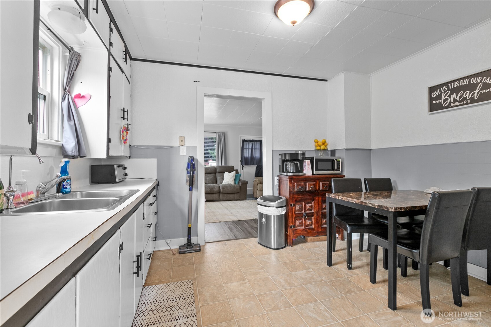 9112 Axling Road Lynden, WA 98264 - Photo 21 of 38 a kitchen with a table chairs sink and cabinets