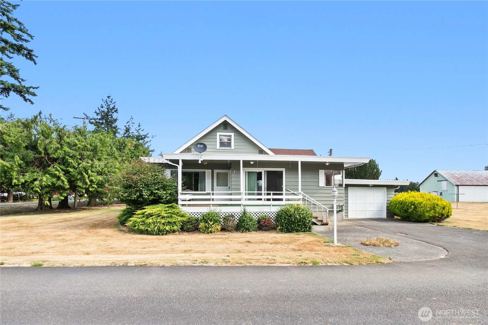 9112 Axling Road Lynden, WA 98264 - Photo 3 of 38 a front view of a house with a yard and potted plants