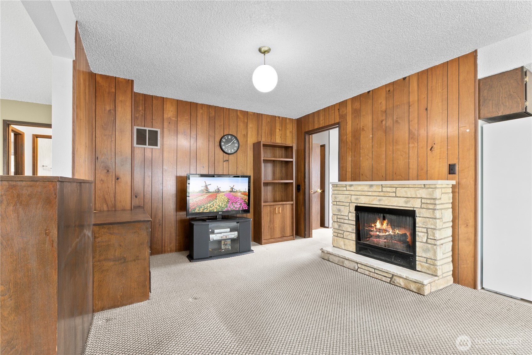 9112 Axling Road Lynden, WA 98264 - Photo 6 of 38 a living room with furniture a flat screen tv and a fireplace