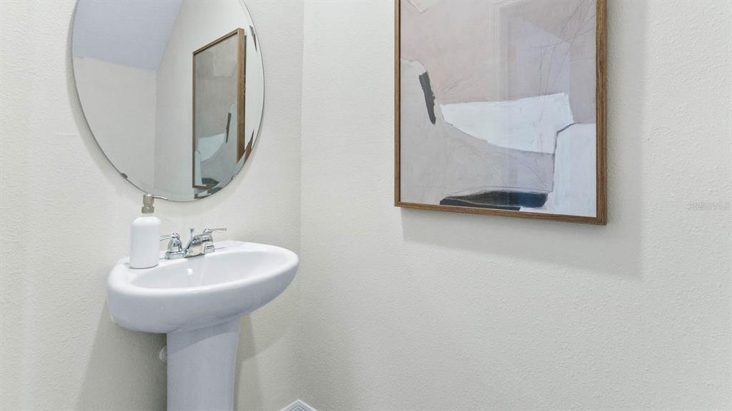 31199 Midnight Sun Way Wesley Chapel, FL 33545 - Photo 14 of 22 a bathroom with a sink and a mirror
