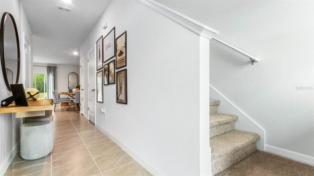 31199 Midnight Sun Way Wesley Chapel, FL 33545 - Photo 5 of 22 a hallway with couches and painted walls