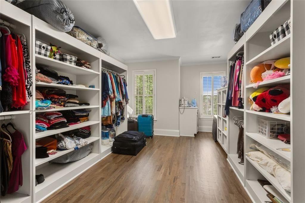 415 Lyerly Pointe Alpharetta, GA 30022 - Photo 46 of 62 a view of walk in closet with clothes and shoes