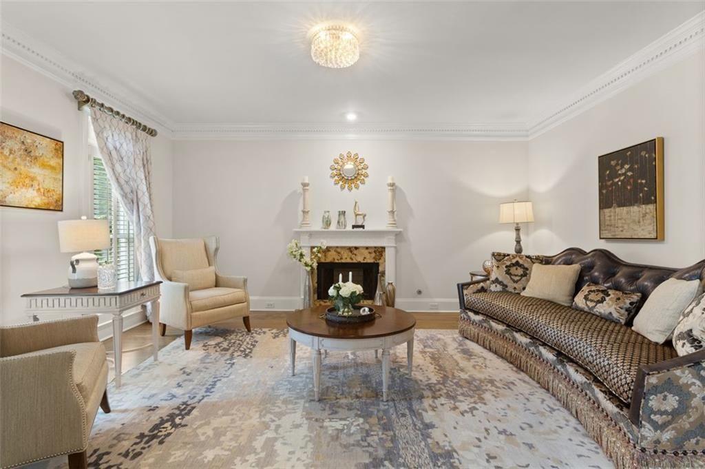 415 Lyerly Pointe Alpharetta, GA 30022 - Photo 7 of 62 a living room with furniture a fireplace and a table