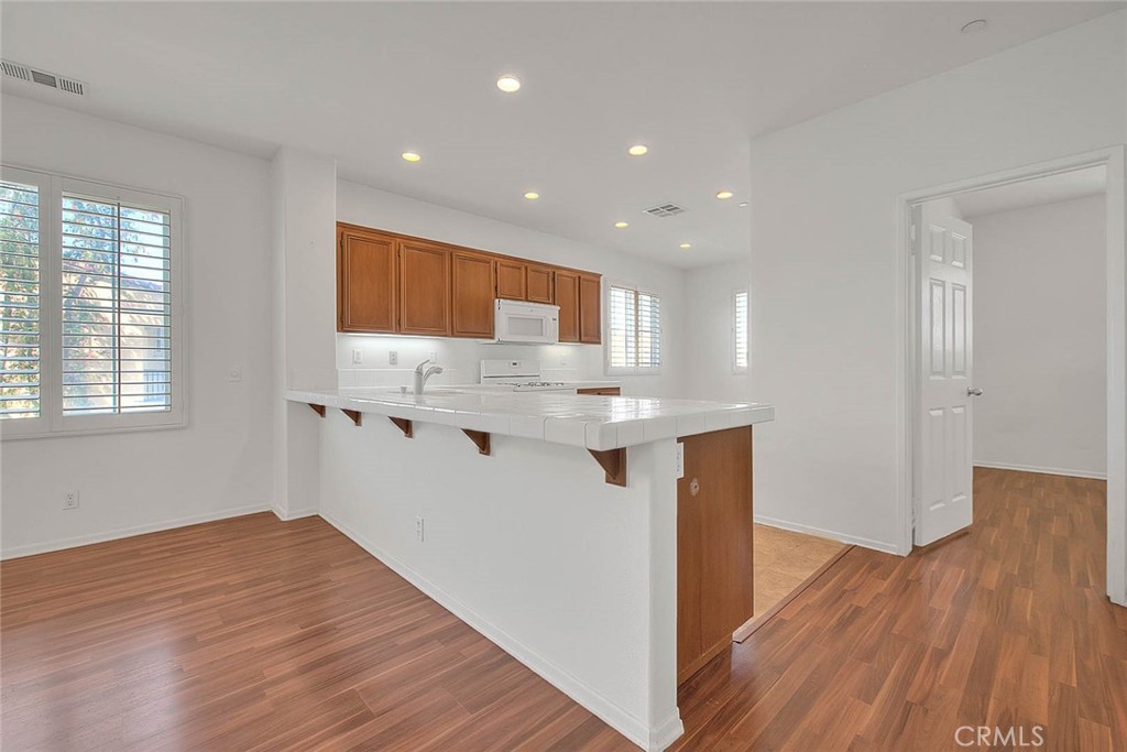 8150 West Preserve Loop Chino, CA 91708 - Photo 15 of 51 a view of kitchen with wooden floor and electronic appliances
