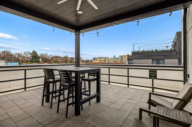 a view of a chairs and table in the balcony