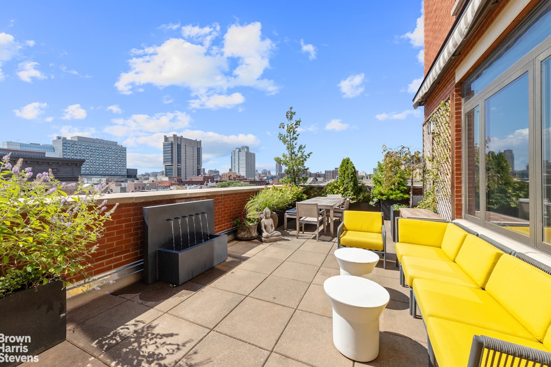a view of a swimming pool with outdoor seating