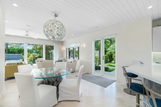 a living room with furniture a large window and a clock