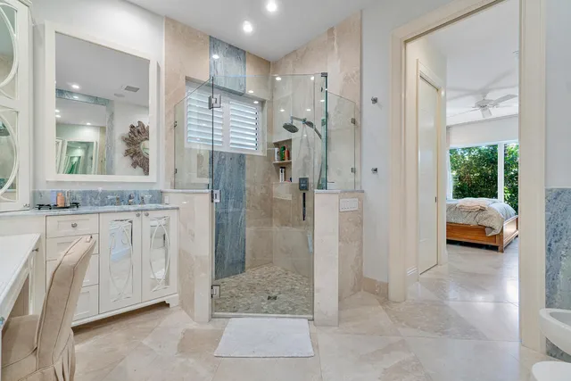 a en suite bathroom with a shower and a sink