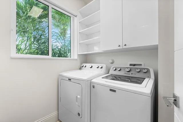 a view of a backyard with lawn chairs