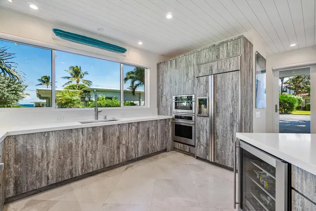 a kitchen with stainless steel appliances a refrigerator and a sink
