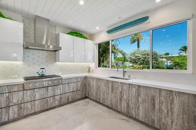 a kitchen with a sink window and cabinets