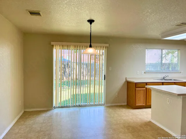 a view of a kitchen with a sink cabinet and a window