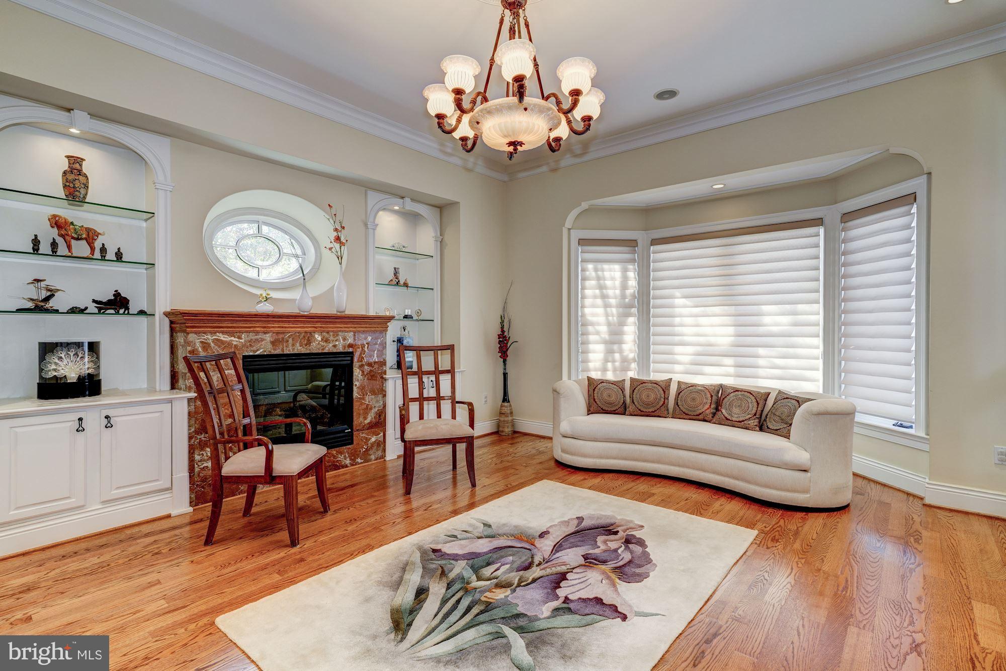 3809 Jones Bridge Road Chevy Chase, MD 20815 - Photo 11 of 70 a living room with furniture a fireplace and a table