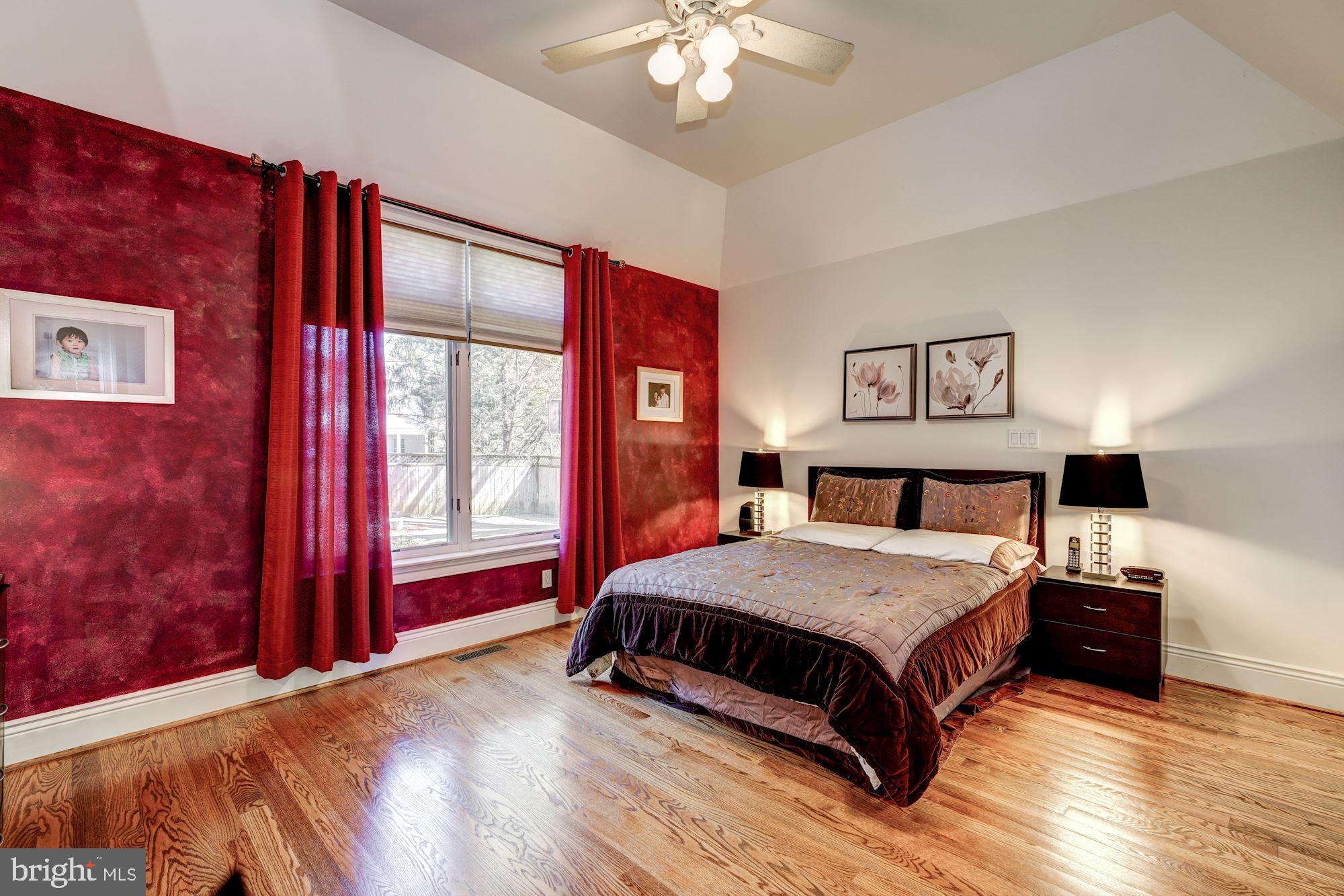 3809 Jones Bridge Road Chevy Chase, MD 20815 - Photo 15 of 70 a bedroom with a large bed and a chandelier