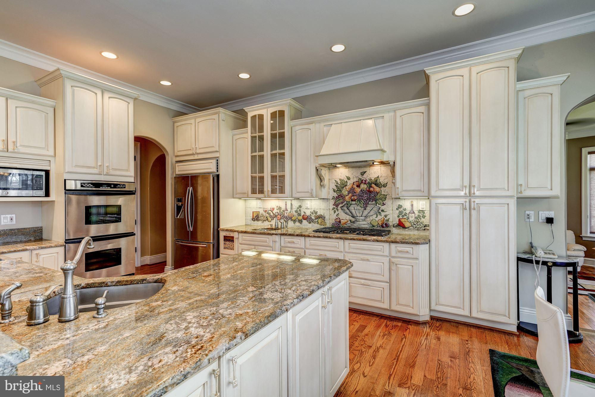 3809 Jones Bridge Road Chevy Chase, MD 20815 - Photo 21 of 70 a kitchen with stainless steel appliances granite countertop a stove and a refrigerator