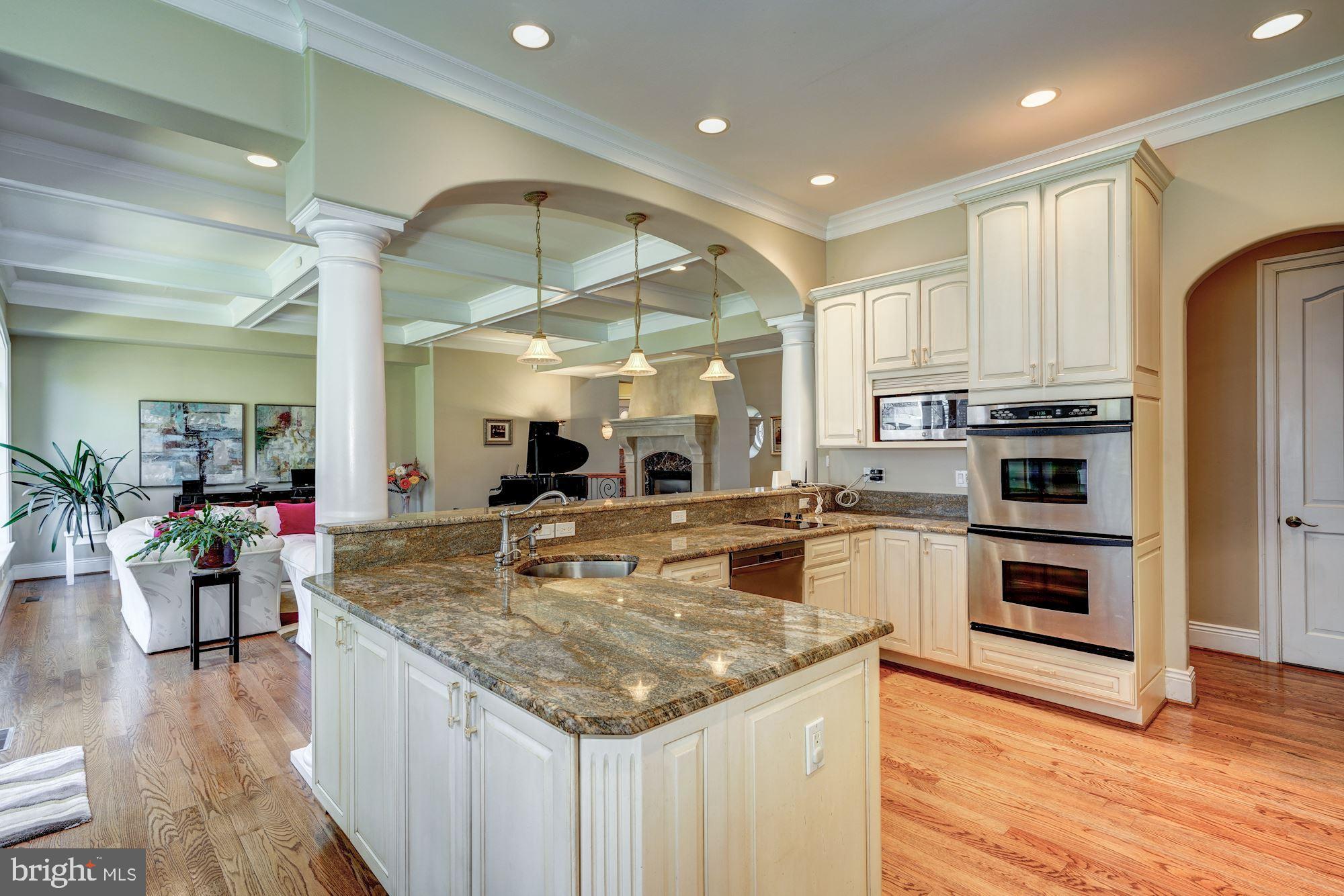 3809 Jones Bridge Road Chevy Chase, MD 20815 - Photo 23 of 70 a large kitchen with kitchen island a large counter top appliances and cabinets