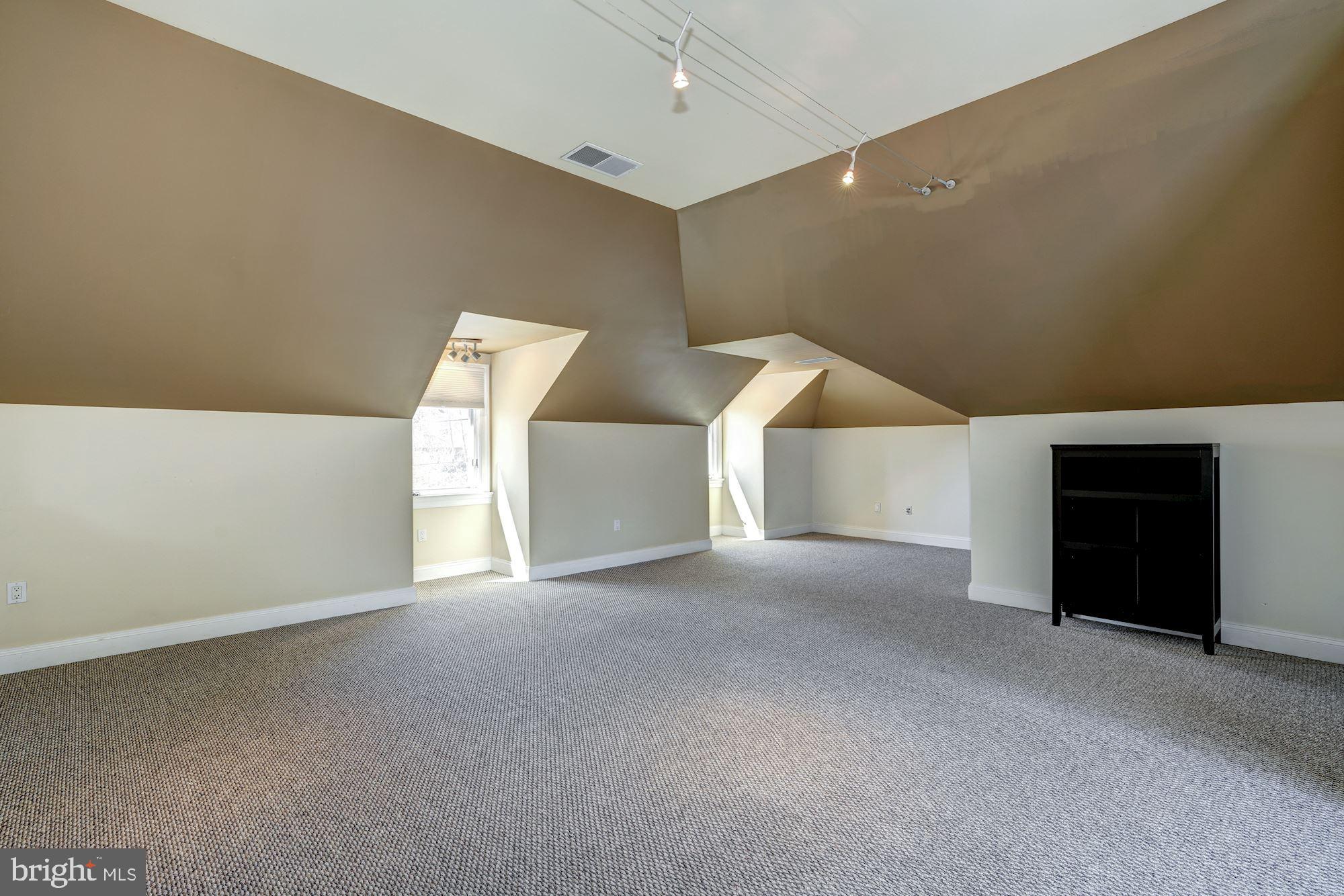 3809 Jones Bridge Road Chevy Chase, MD 20815 - Photo 35 of 70 a view of an empty room with a fireplace