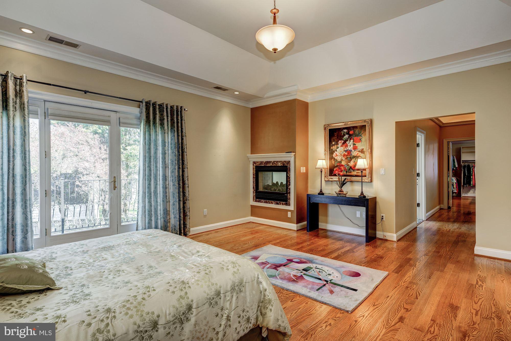 3809 Jones Bridge Road Chevy Chase, MD 20815 - Photo 37 of 70 a bedroom with a bed and a dresser with wooden floor