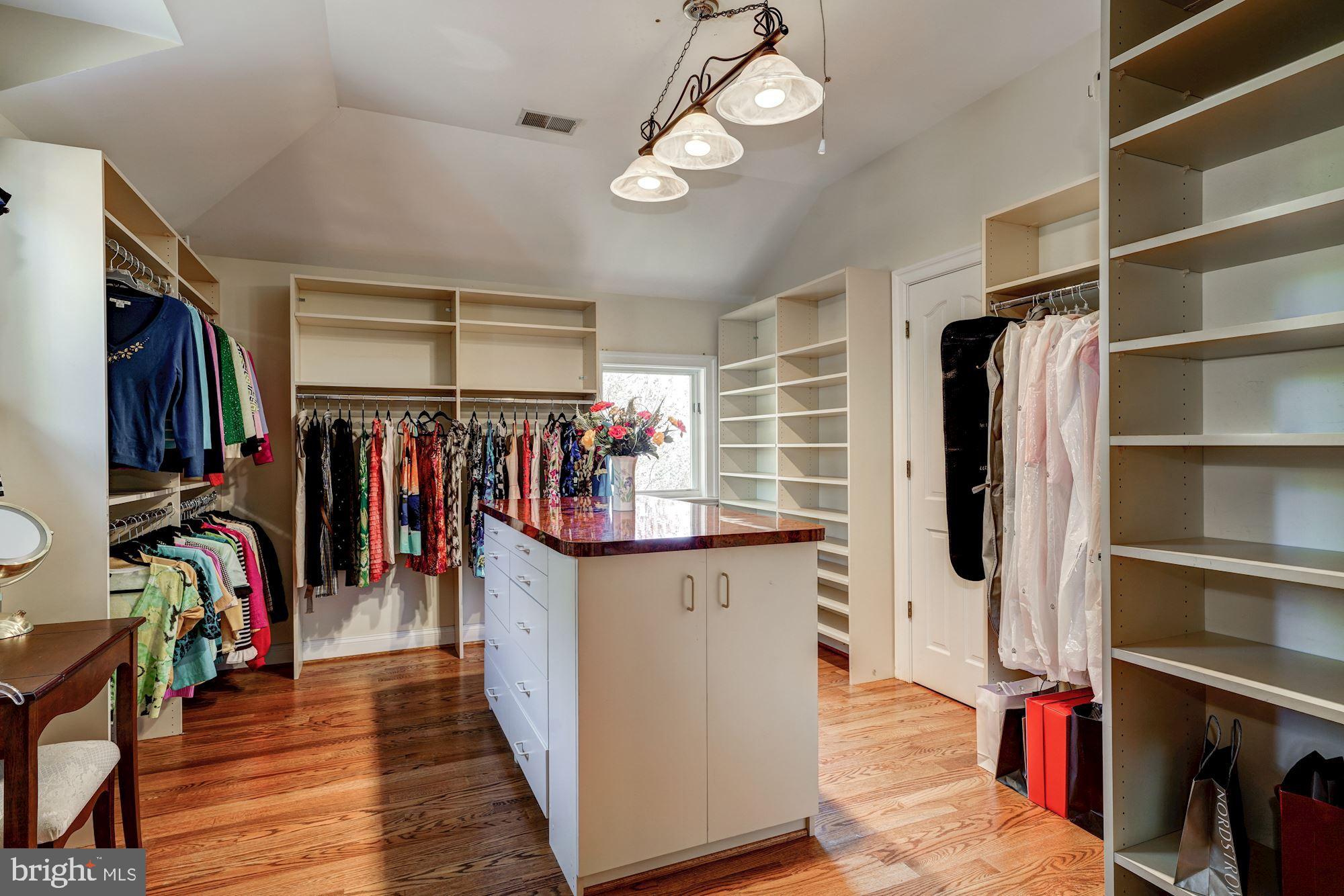3809 Jones Bridge Road Chevy Chase, MD 20815 - Photo 38 of 70 a view of a walk in closet with clothes and shoes