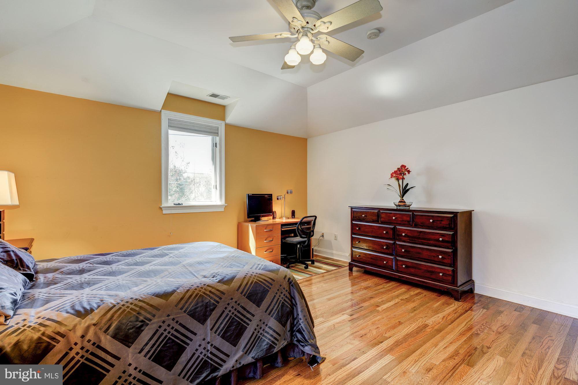 3809 Jones Bridge Road Chevy Chase, MD 20815 - Photo 45 of 70 a bedroom with a bed and a chandelier