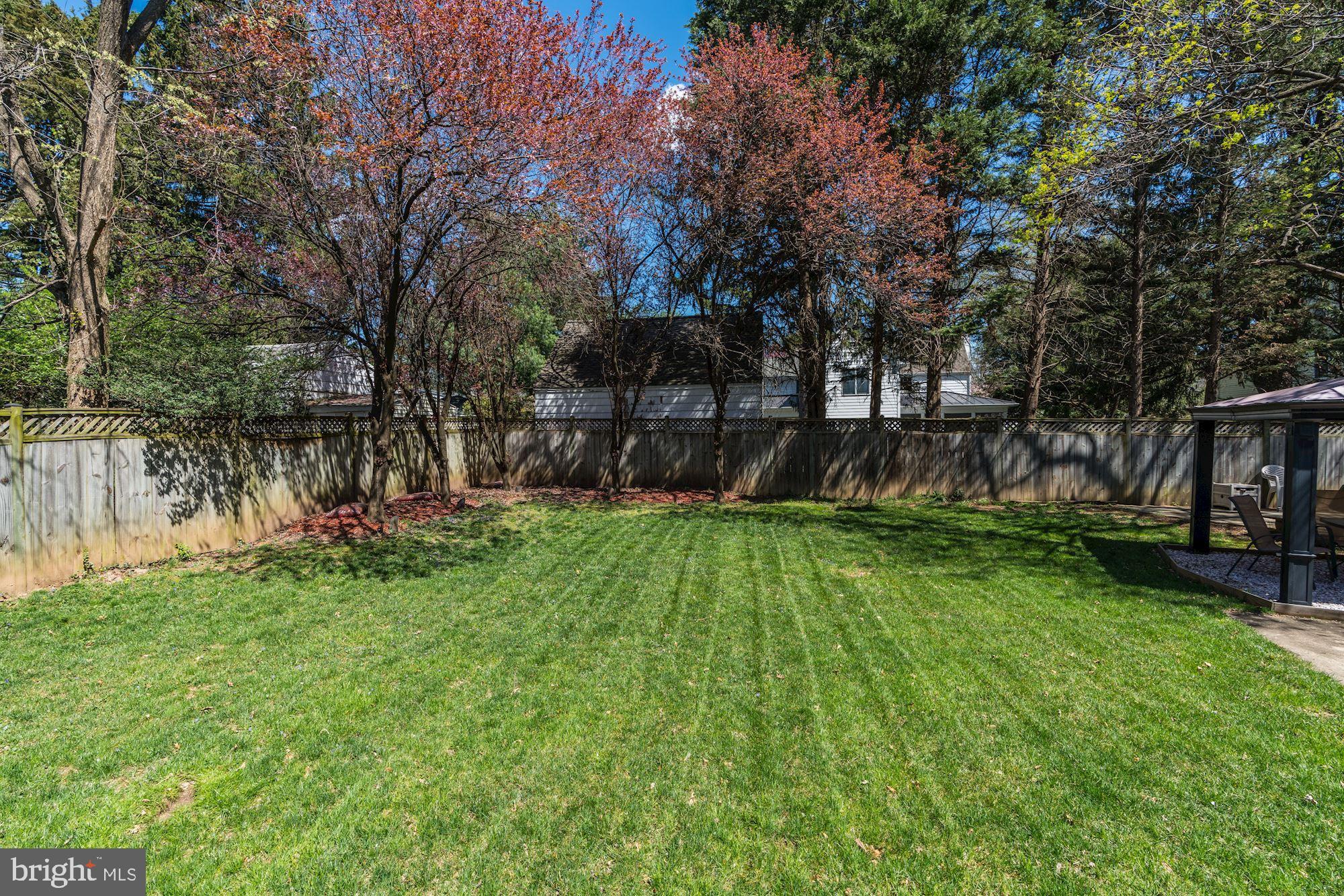 3809 Jones Bridge Road Chevy Chase, MD 20815 - Photo 64 of 70 a view of a backyard with a table and a slide