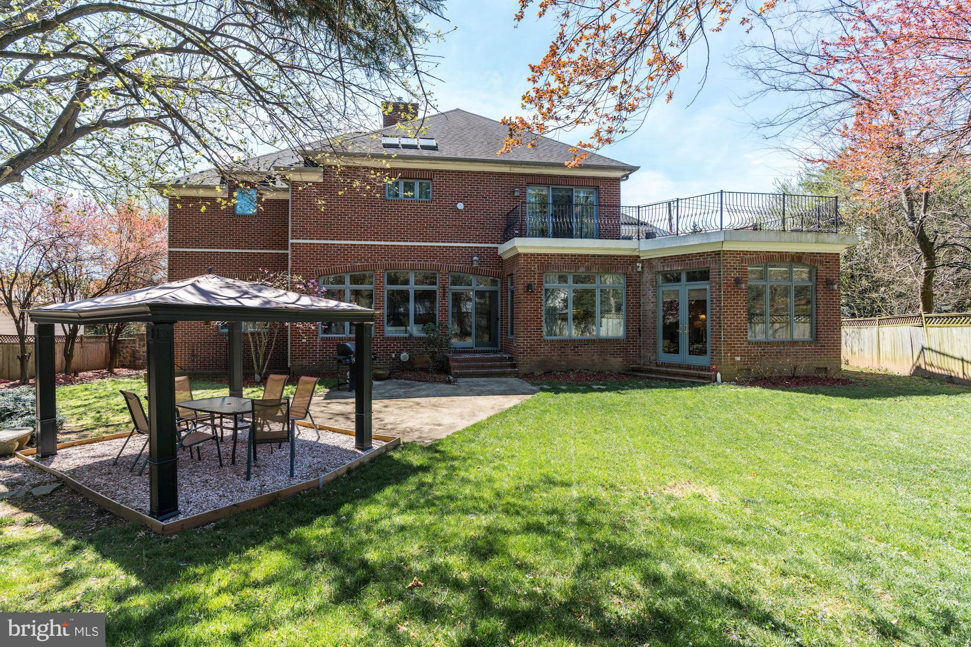 3809 Jones Bridge Road Chevy Chase, MD 20815 - Photo 67 of 70 a view of a patio with table and chairs potted plants and a large tree