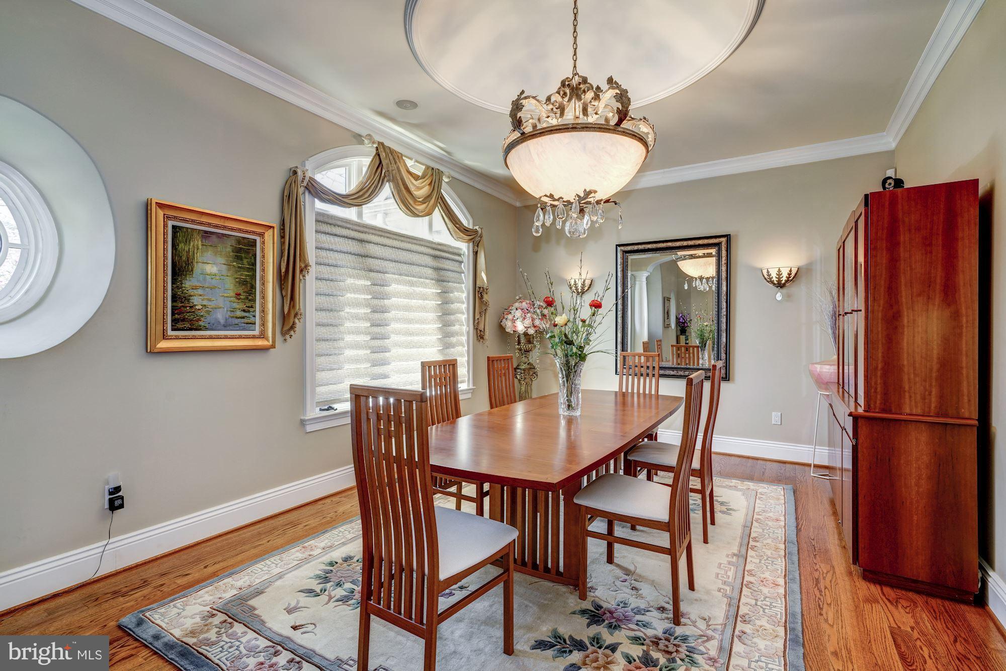 3809 Jones Bridge Road Chevy Chase, MD 20815 - Photo 9 of 70 a dining room with furniture a chandelier and wooden floor