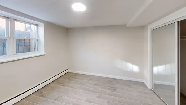 an empty room with windows and closet