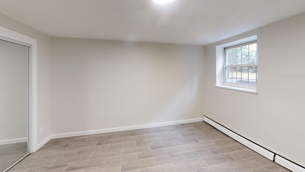 51 Colborne Road, Unit B2 Boston, MA 02135 - Photo 3 of 7 wooden floor in an empty room with a window