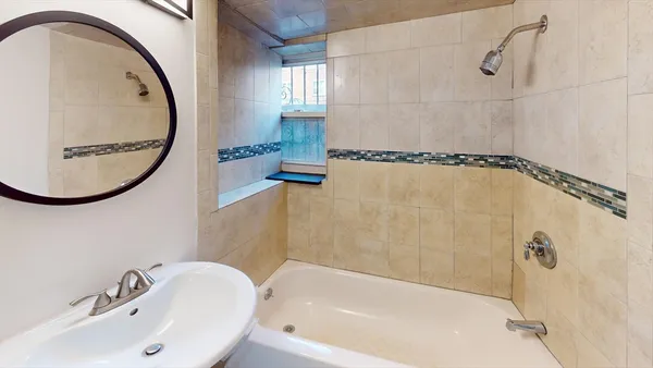 a bathroom with a sink a bathtub and a shower